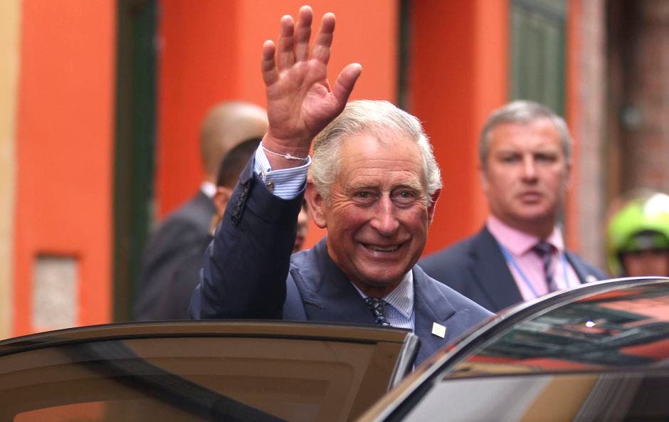 Britain's Prince Charles waves after visiting an organic fair at the British Ambassador's residence in Bogota