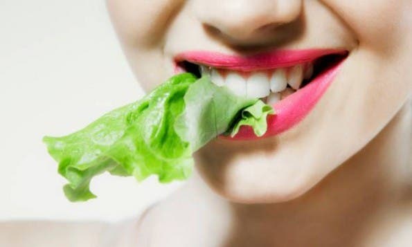 Woman-eating-vegetables-595x357